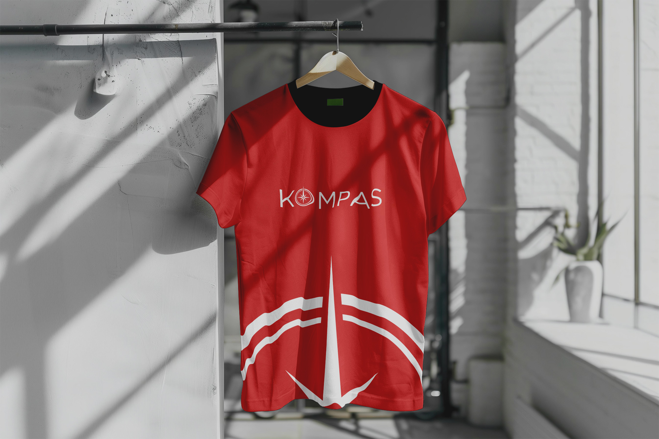 Kompass rebranding logo printed on hanging T-shirt mockup